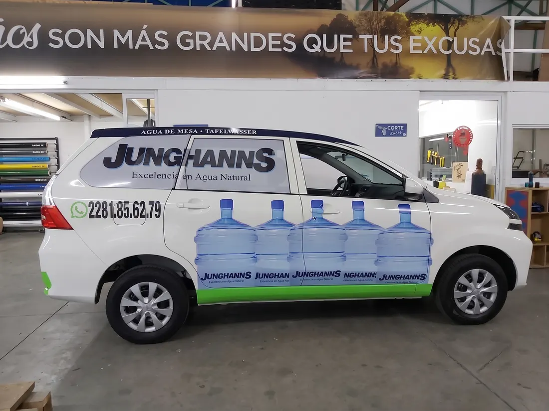 Camioneta de reparto rotulada con la marca Junghanns y garrafones de agua